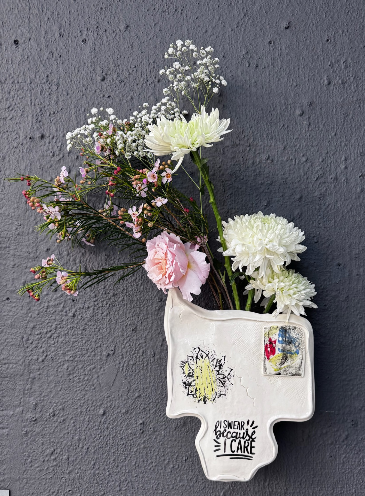 Hand-built ceramic wall vase with flowers, exhibited at Vuleka 2026, artB gallery